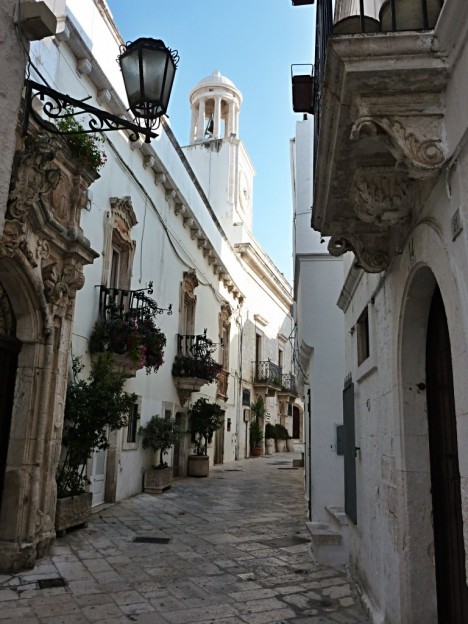 Locorotondo street in the city center and clock tower, Puglia, Italy